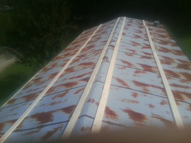 Rusted metal roof panels with new wood purlins before replacement — Storm Damage Roof Repair in Bush by Roofing Brothers